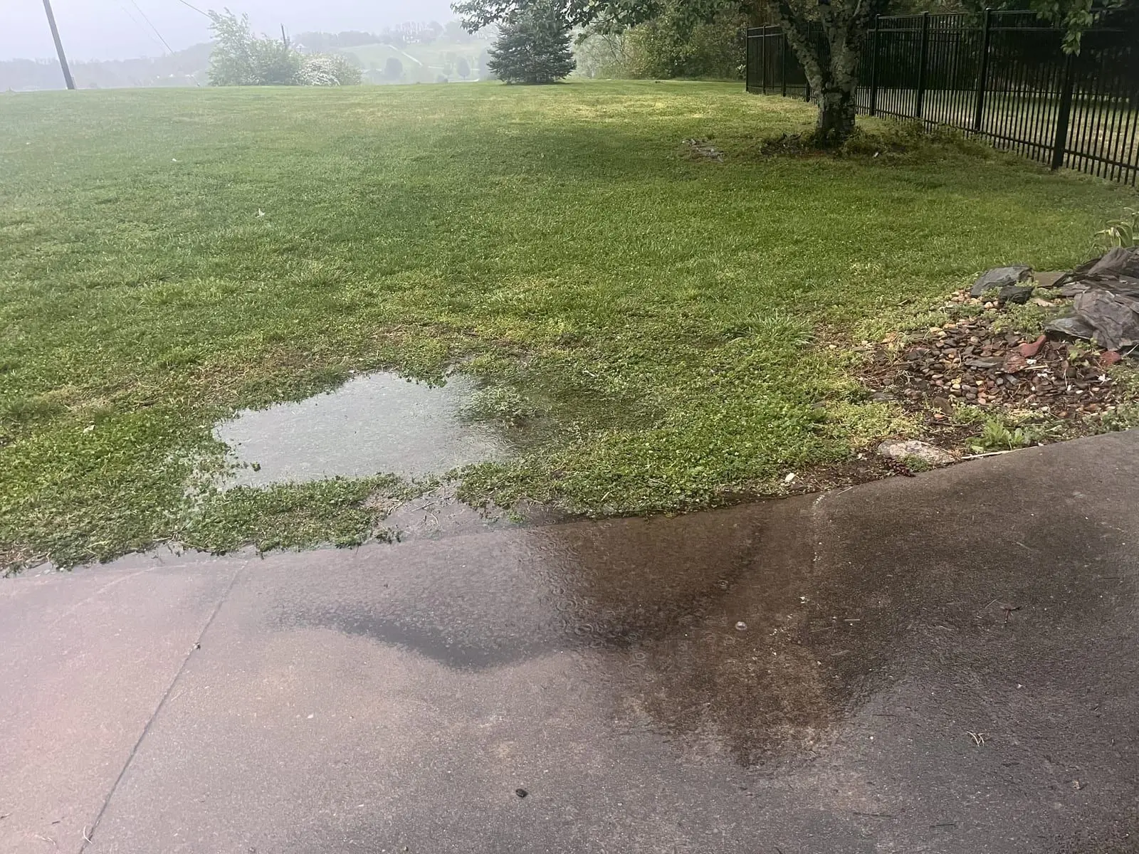 Standing water pooling along a driveway edge