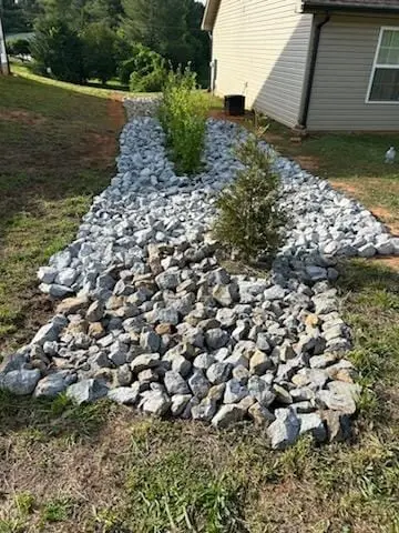 Riprap dry-creek swale between two houses