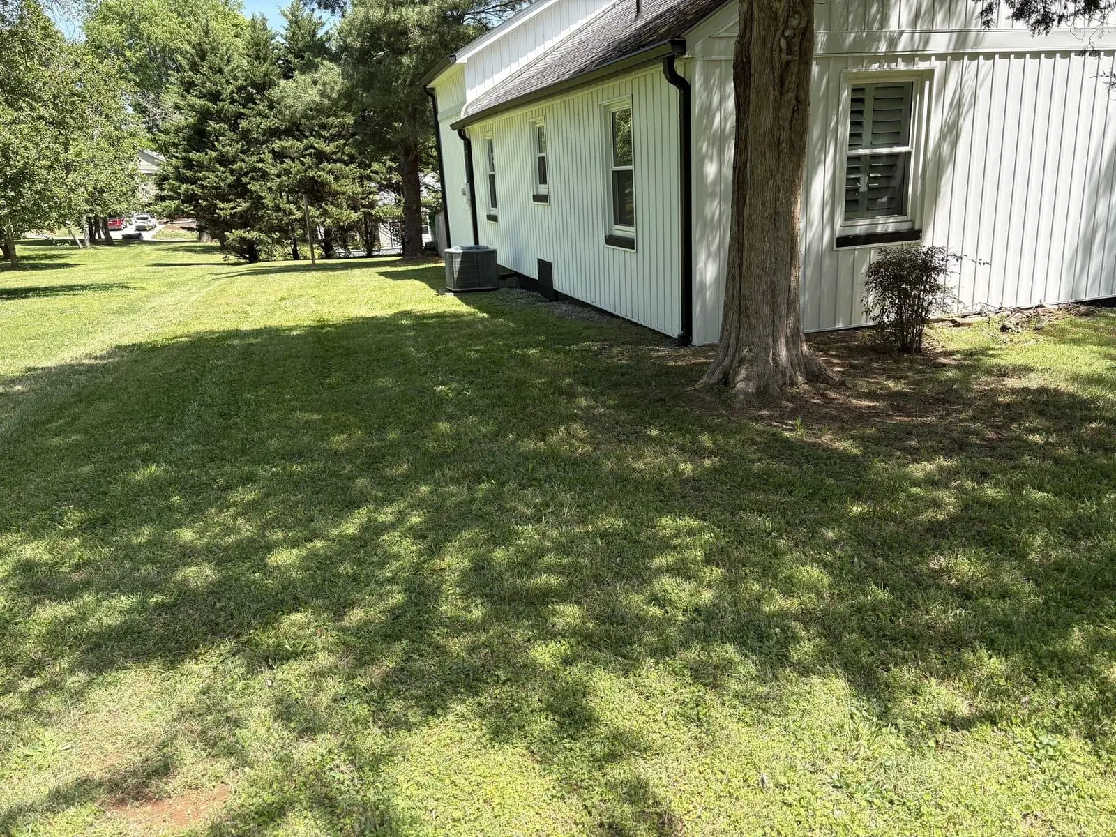 Fresh mow at a white farmhouse lawn