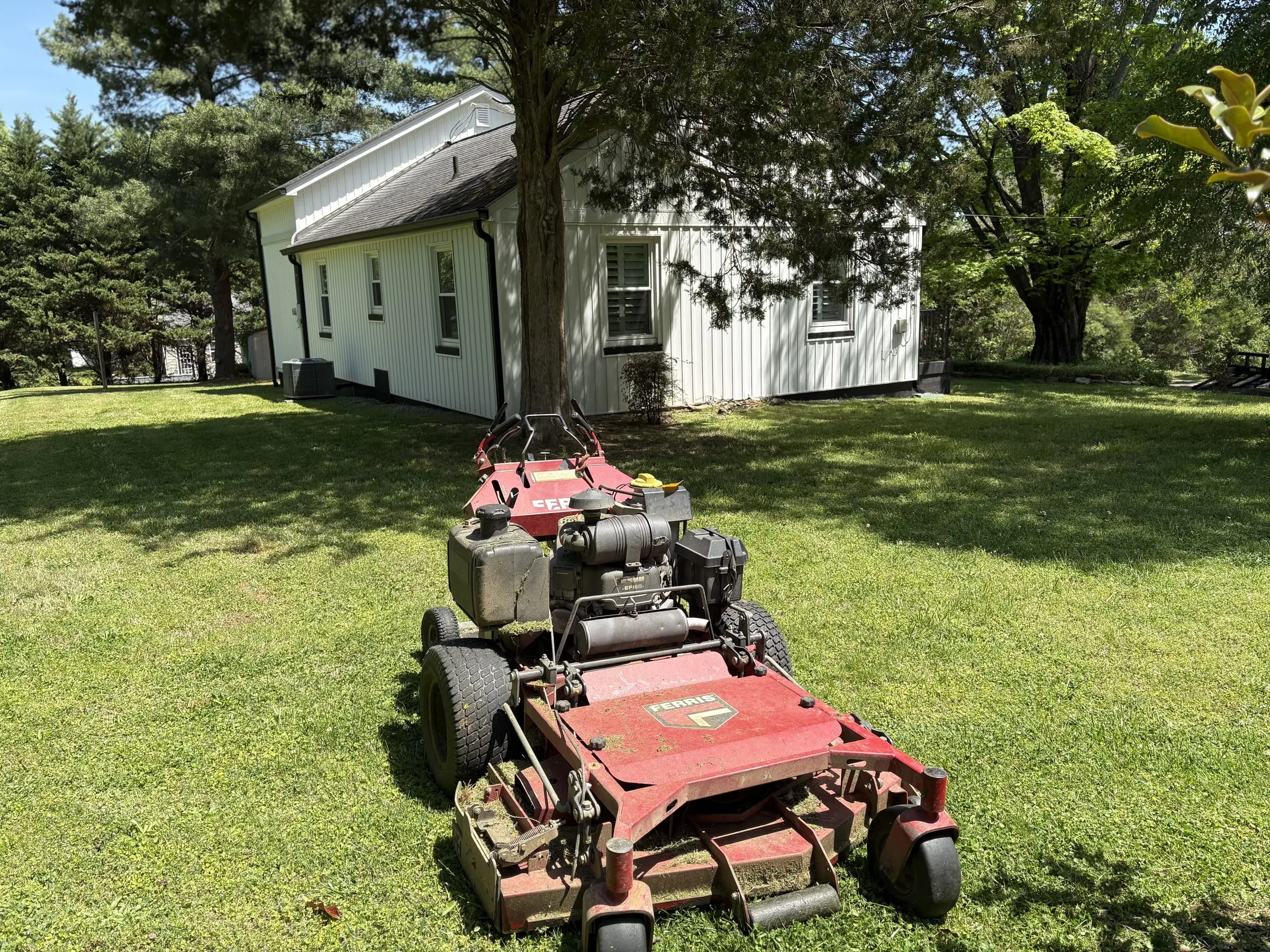 Freshly mowed farmhouse lawn with clean stripe lines in Blount County