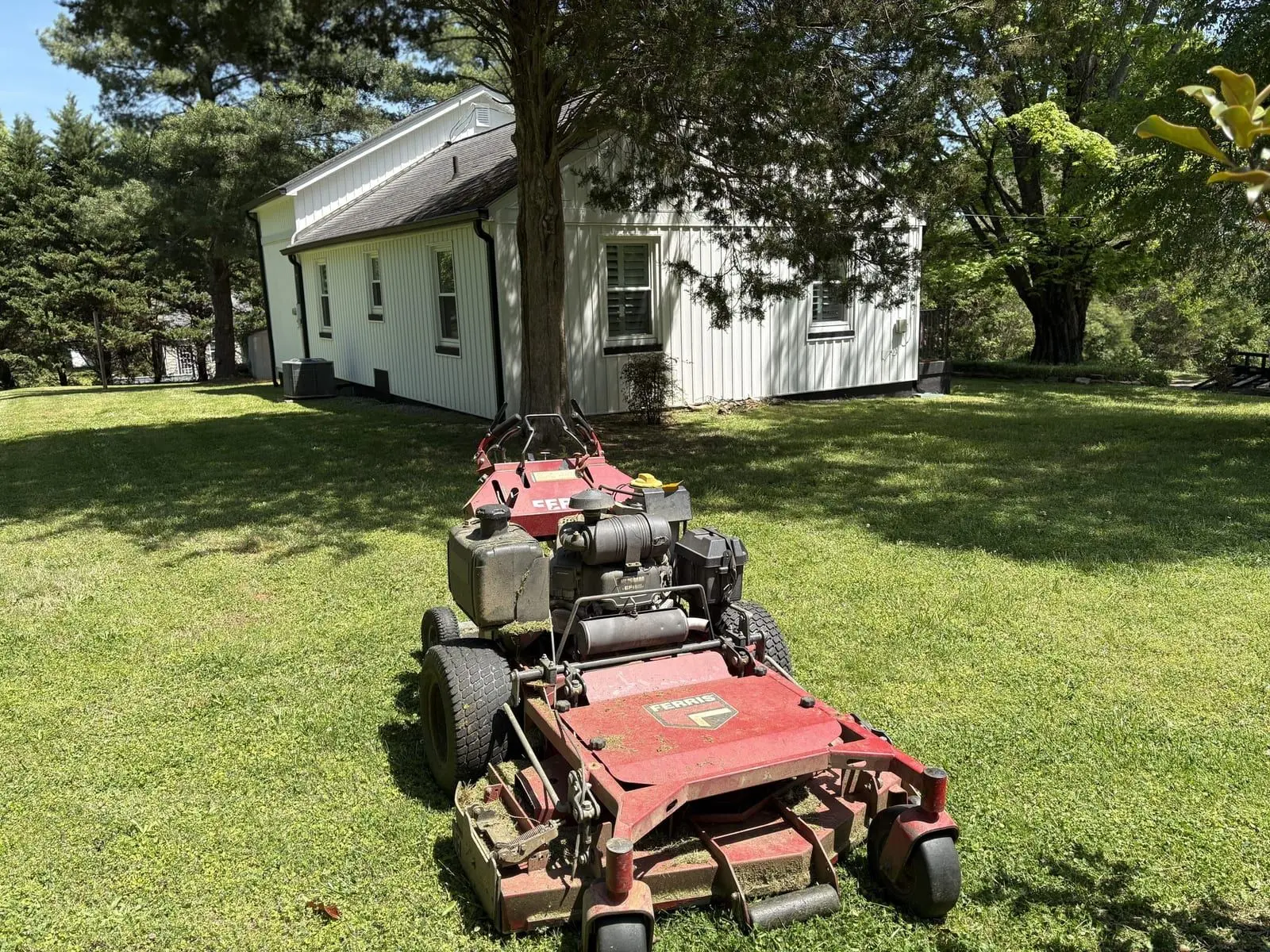 Freshly mowed farmhouse lawn with clean stripe lines in Blount County