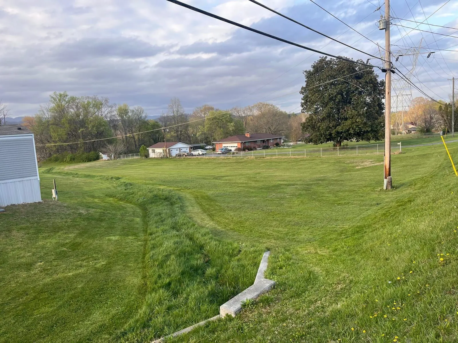 Large mowed green lawn on a rural Oliver Springs property