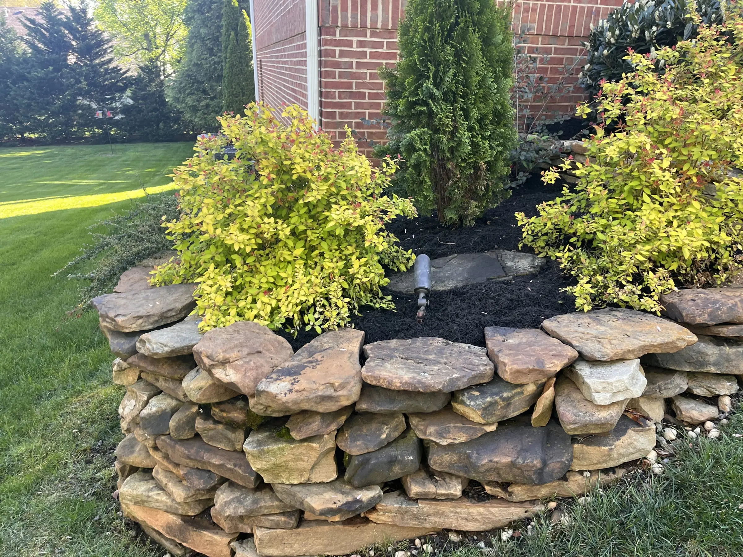 Pondless waterfall and stacked-stone landscape build