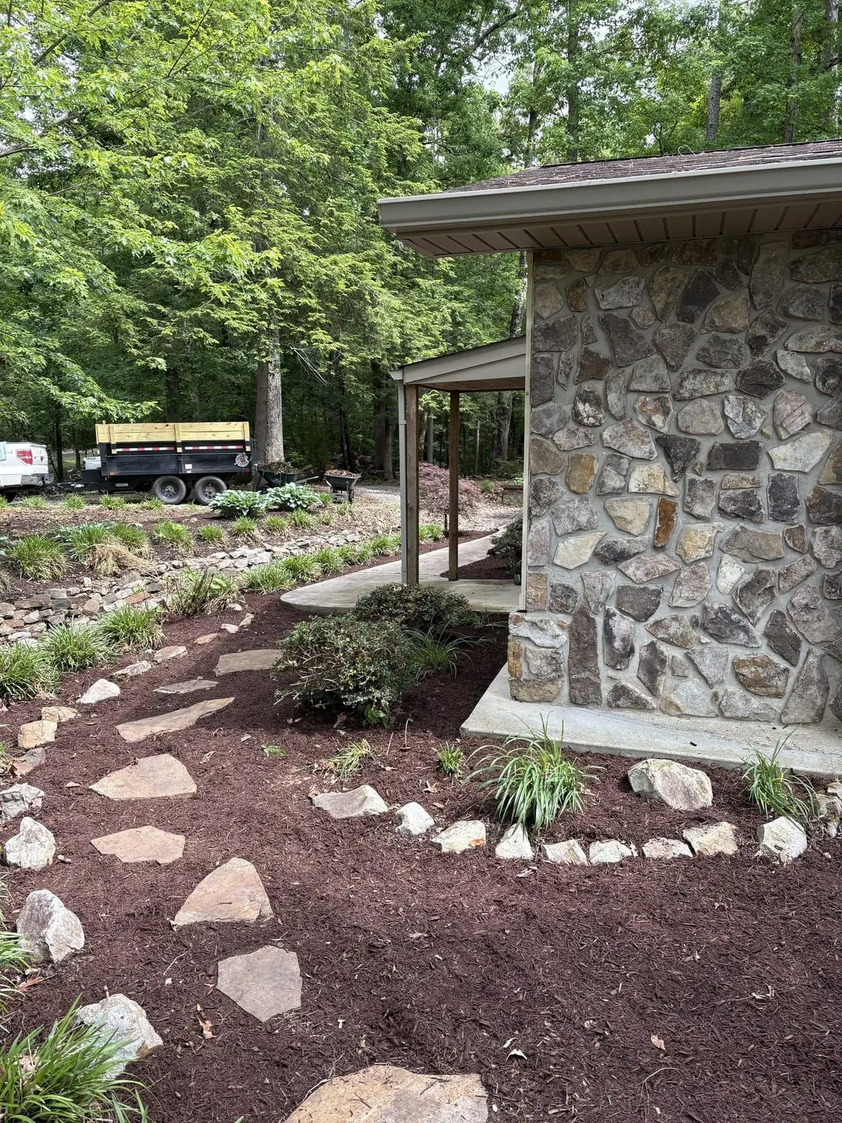 Lush hostas and a stone path at a home's front entry